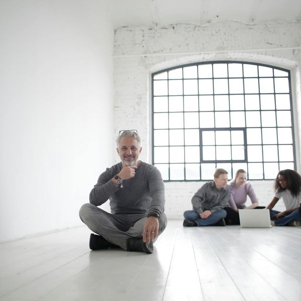 A diverse group of people sitting peacefully in a bright room.
